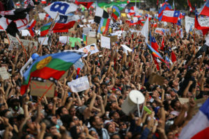 Chile Protests: Demonstrators march with flags and signs during a protest against Chile’s state economic model in Santiago, Chile October 25, 2019. REUTERS/Ivan Alvarado