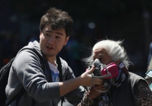 Chile protests: A woman wears a gas mask during an anti-government protests in Santiago, Chile October 28, 2019. REUTERS/Edgard Garrido